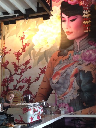 The beautiful wall painting by Emma Hack - Madame Hanoi - body painted and photographed, placed on a painted background